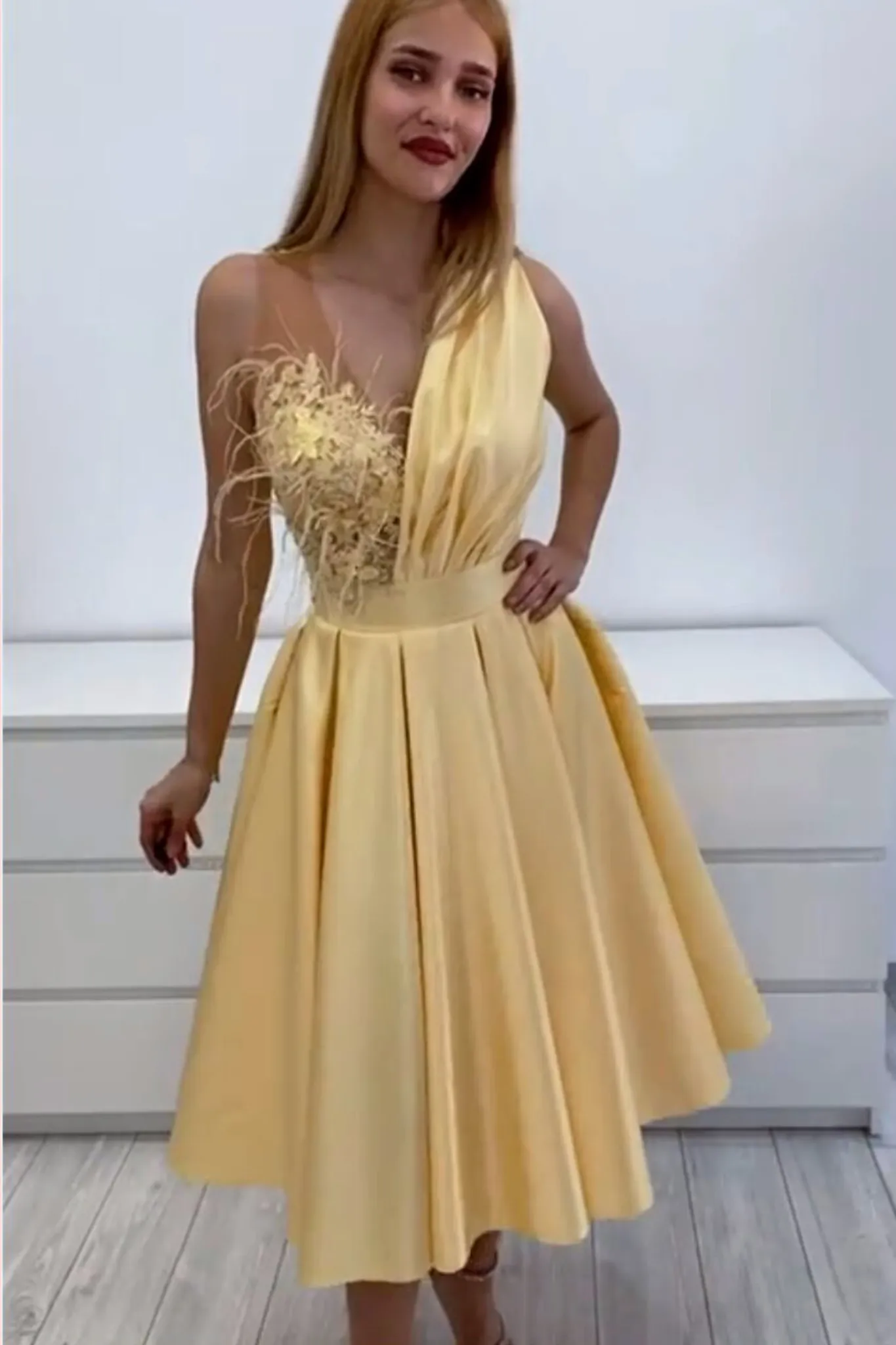 Abito svasato giallo Axa lunghezza midi con corpetto floreale e piume decorative